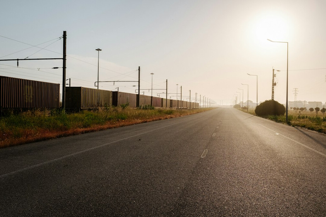 Car on an empty road at sunrise